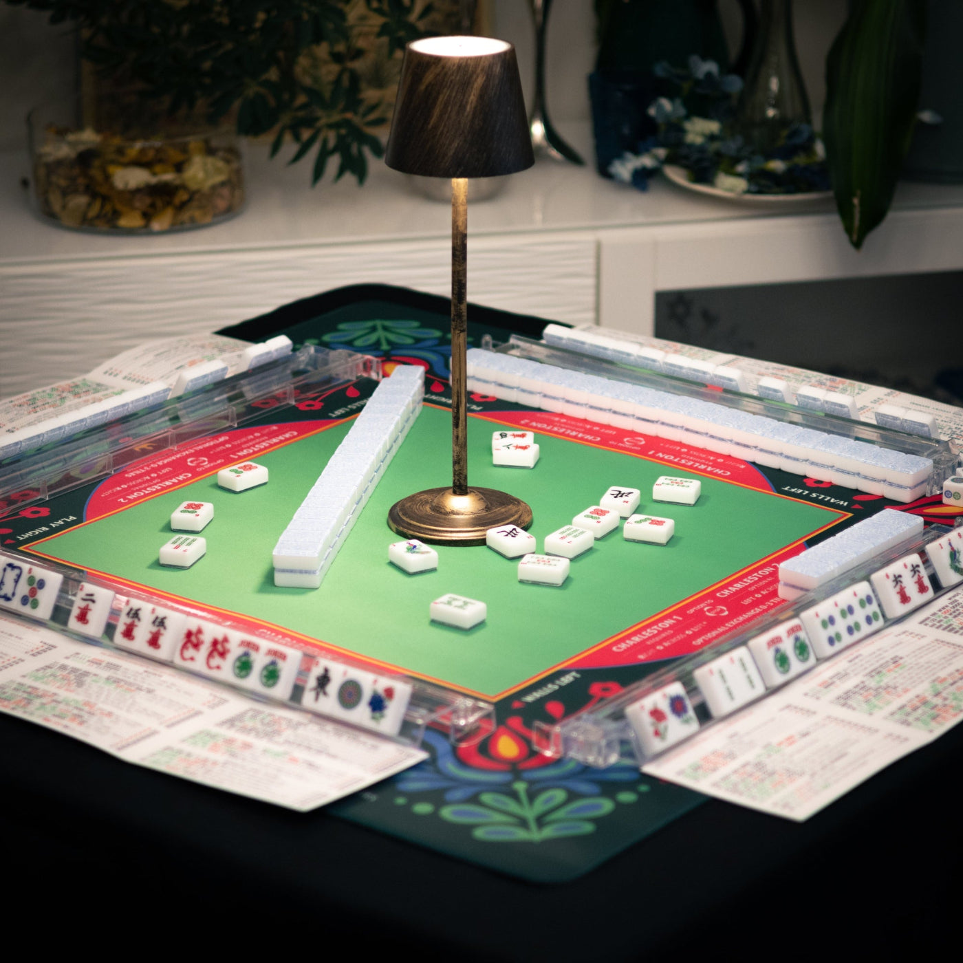 A lifestyle image of the Modern Classic American Mahjong tiles from Mahj Queen™ on the Queen Bee mat.  This set features modernized designs for easier identification—with classic red, green and blue ink coloring.