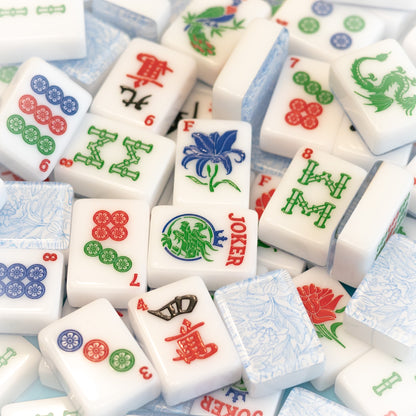 An image of a jumble of tiles from the Modern Classic tile line from Mahj Queen™.  It highlights the classic colors of the tiles, beautiful top layer design and unique tile artwork.