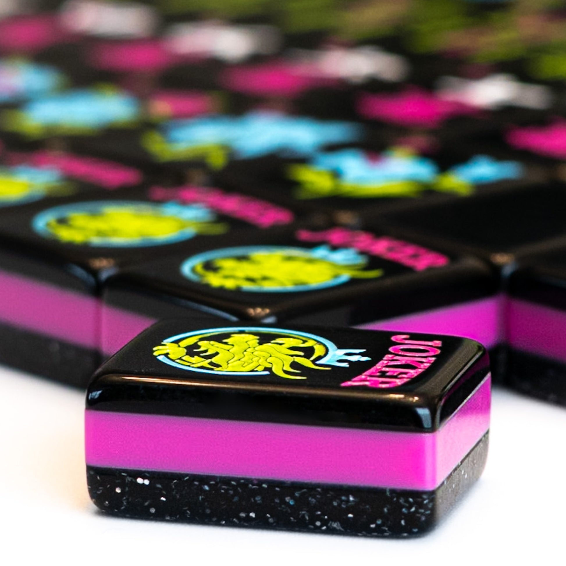 An angled shot of tiles from the Neon Daze mahjong tile line from Mahj Queen™ to show the side view of the set.