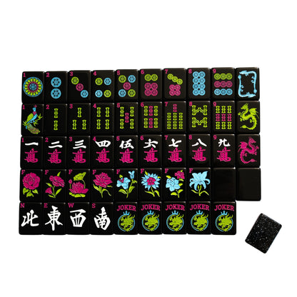 A top down image of the Neon Daze American Mahjong tiles from Mahj Queen™.  This set features modernized designs for easier identification—with black faces and bright neon coloring.